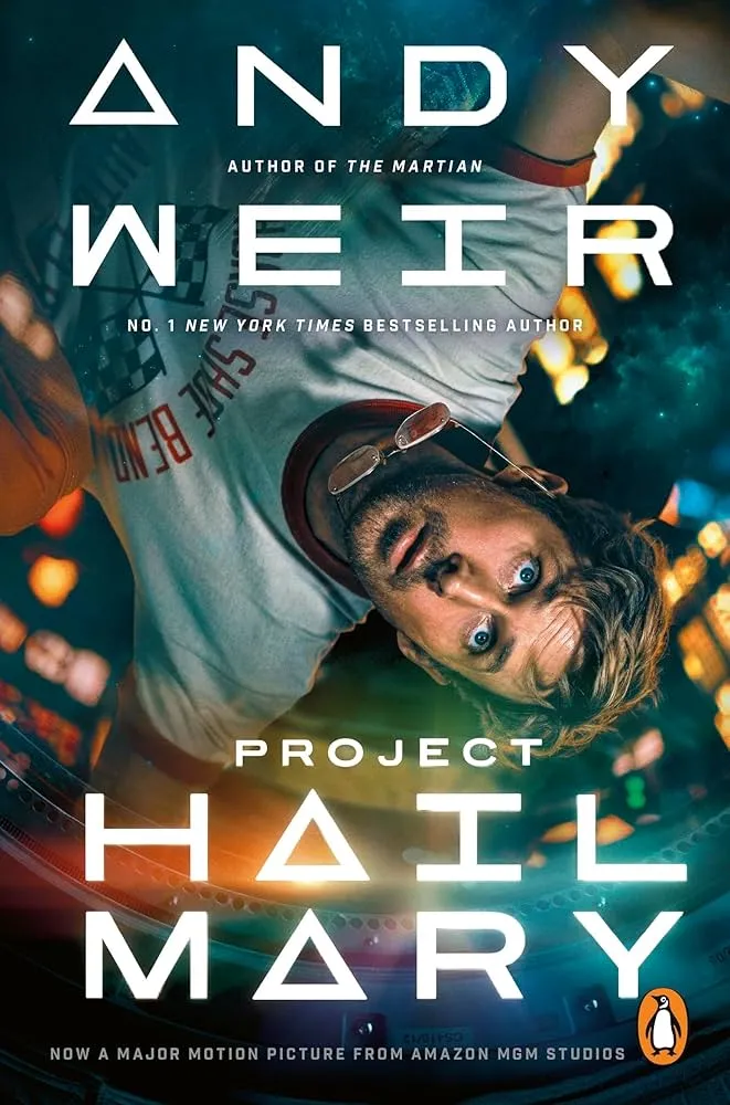 The cover of Project Hail Mary by Andy Weir, movie tie-in edition, showing Ryan Gosling as Ryland Grace floating upside down in a spaceship.